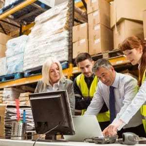 Warehouse managers and worker talking